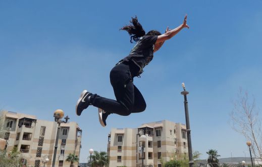 Mariam Emad from Parkour Egypt "PKE" practices her parkour skills around buildings on the outskirts of Cairo
