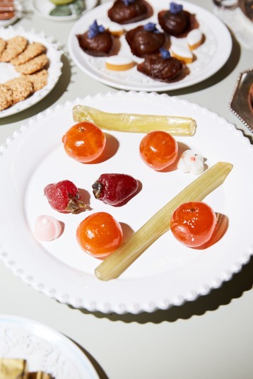 Candied strawberries, oranges and celery for dessert. Two tiny sugar flowers, picked up at the Milan pastry shop Cucchi, also adorned the plate.CreditPaul Quitoriano
