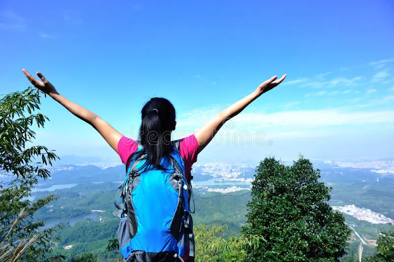 thankful-mountain-climbing-woman-open-arms-peak-35469992-2